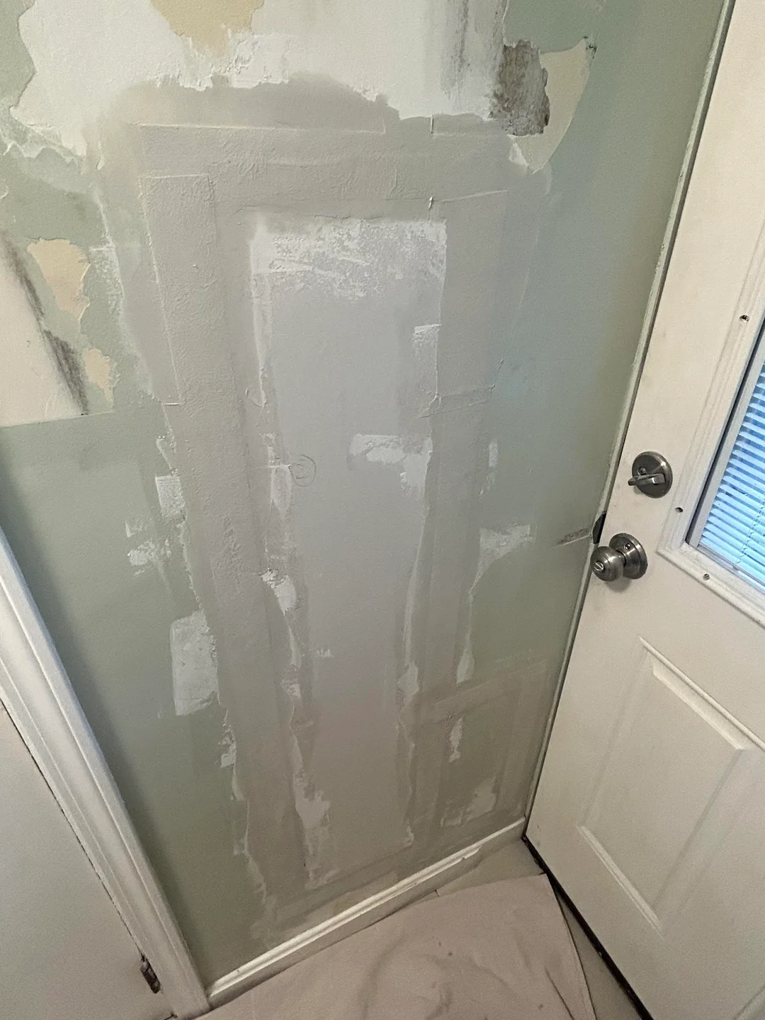 Joint compound covering a drywall patch