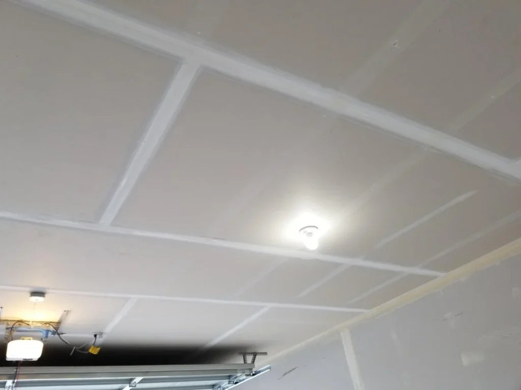 Garage ceiling drywall seams coated and prepared for finishing