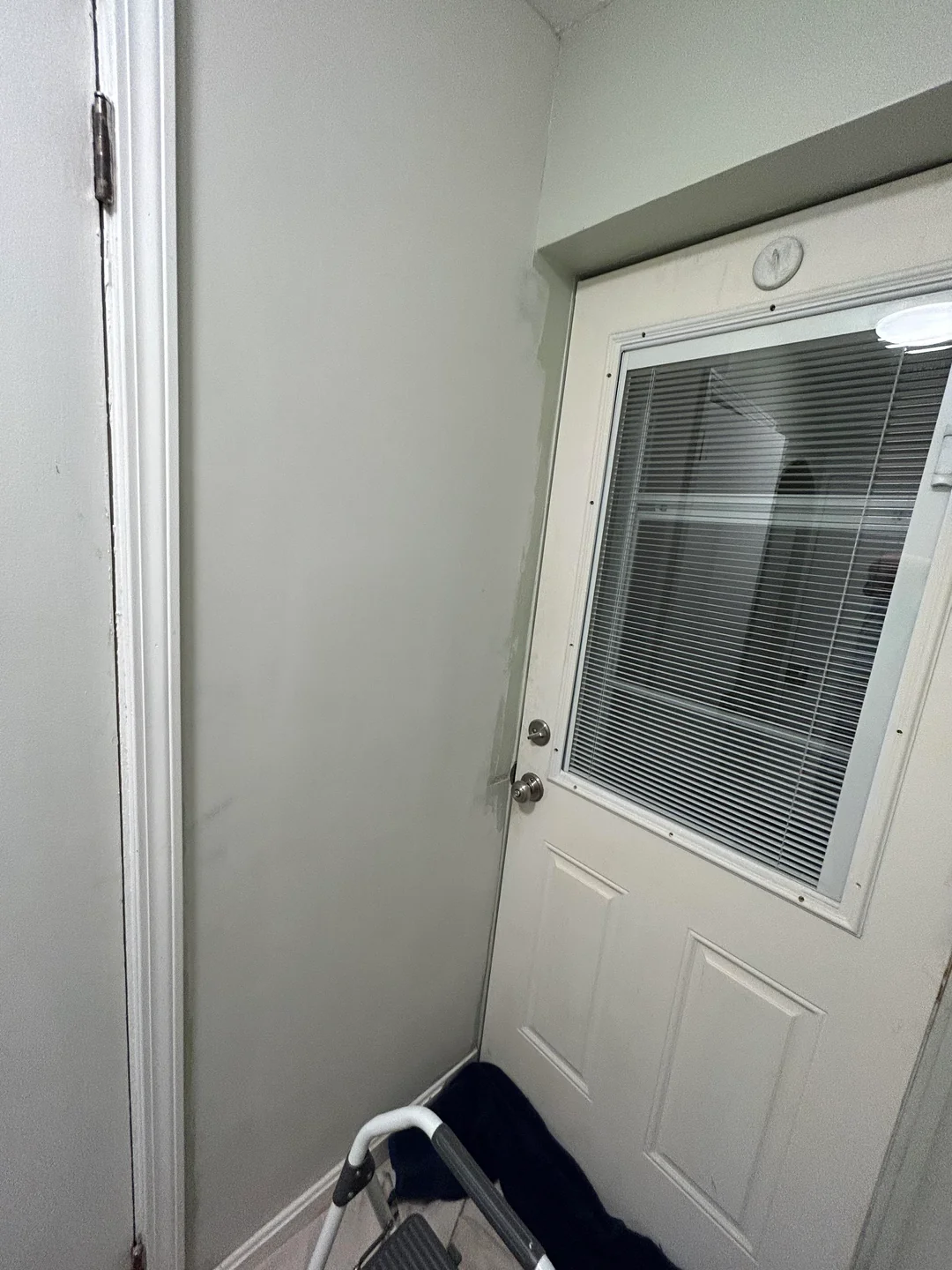 Interior wall beside a door after drywall repair and finish work